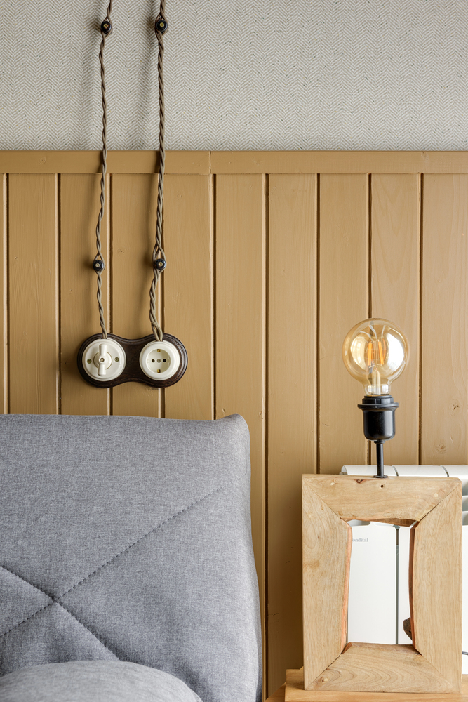 Wood Paneling With Vintage Industrial Details in a Rustic Bedroom