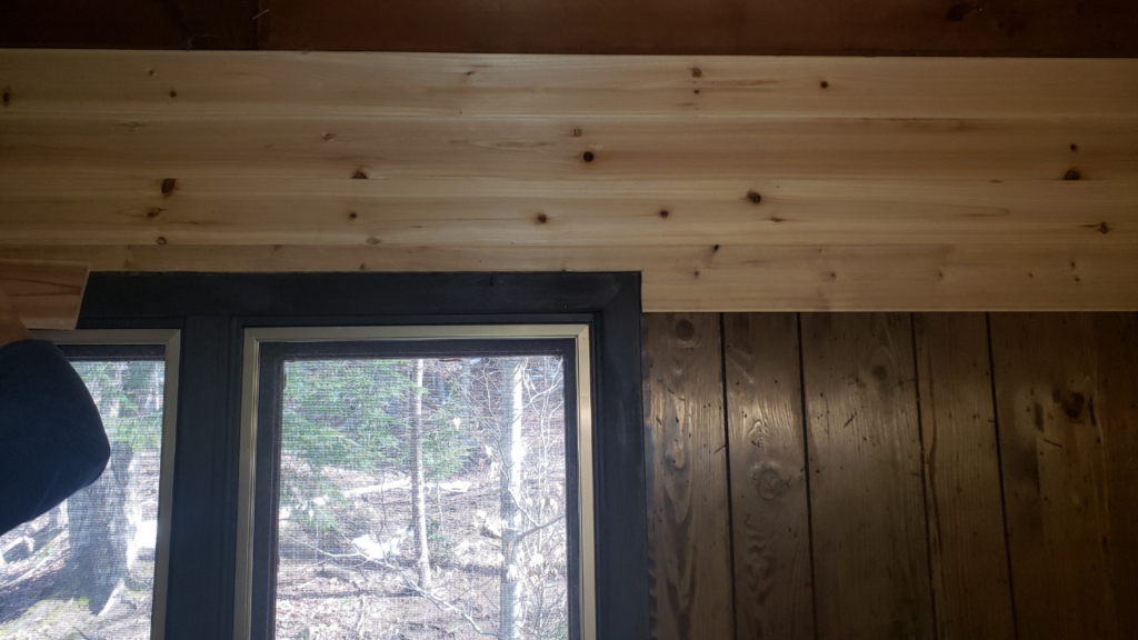 Cedar planks notched and fitted neatly around the window frame