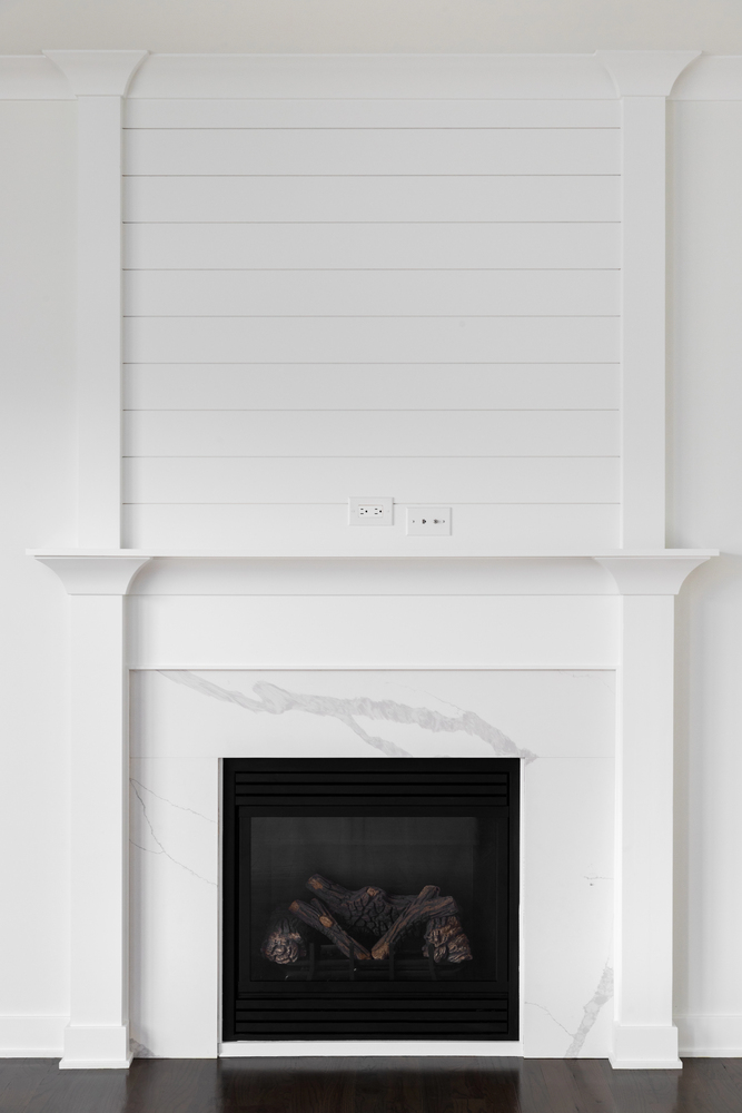 White Shiplap Accent Wall above a Fireplace