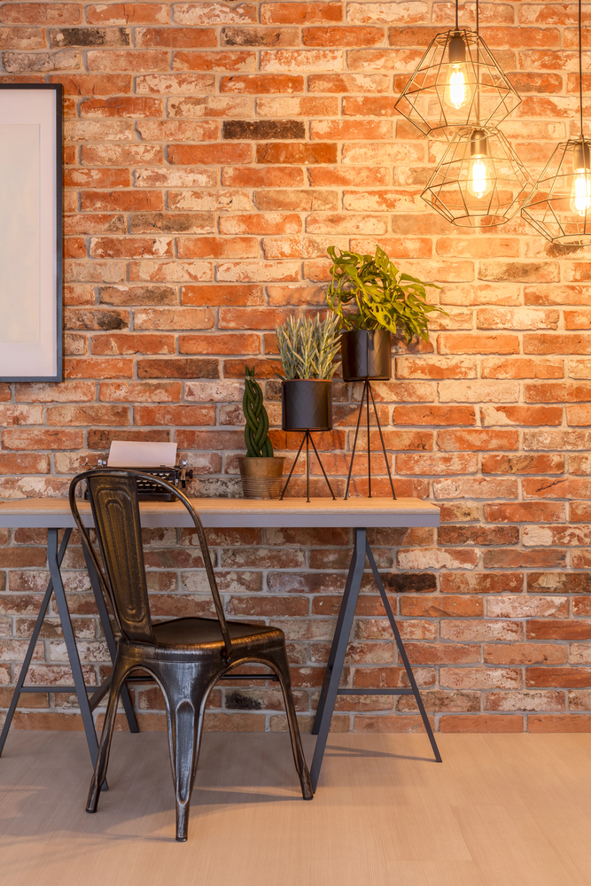 Exposed Brick Office With Industrial Lighting in a Rustic Home Office